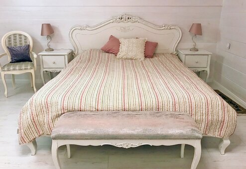 A bed made of natural wood in the Giga Style carpentry and furniture workshop. Order with a discount.