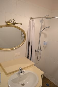 A bathroom with a shower in the room of the Michel hotel in Odessa. Book for the promotion.