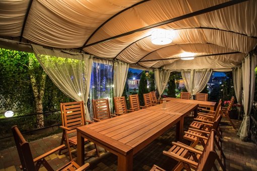 Summer terrace at the Sofiyivsky Posad restaurant in Kiev. Order at a discount